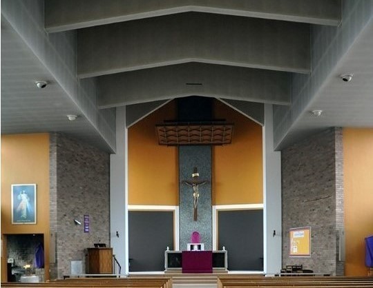 an image of the church altar with brown pews inside