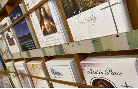 an image of mass and prayers cards on a shelf 